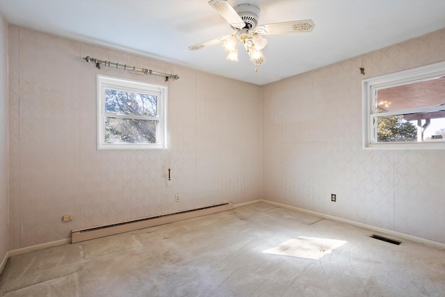 carpeted empty room with ceiling fan and a baseboard radiator