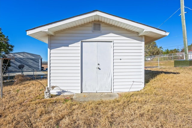 view of outdoor structure with a lawn