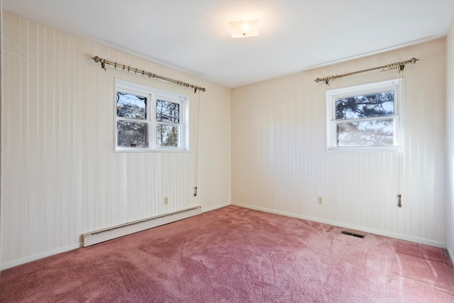 spare room with carpet floors and baseboard heating