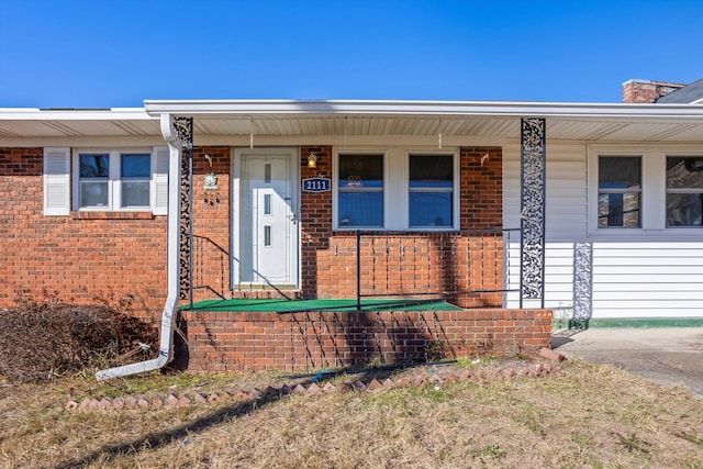 view of exterior entry with covered porch