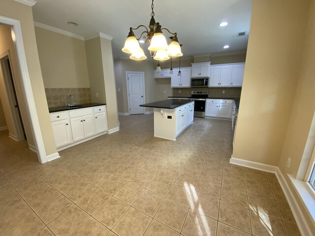 kitchen with white cabinets, decorative backsplash, decorative light fixtures, stainless steel appliances, and a chandelier