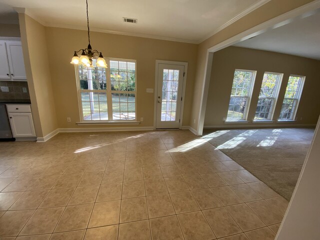 doorway to outside with a notable chandelier, light tile patterned floors, and ornamental molding