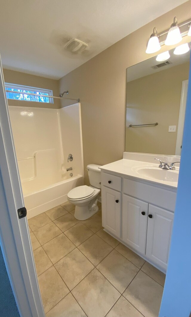 full bathroom with tile patterned floors, vanity, bathtub / shower combination, and toilet