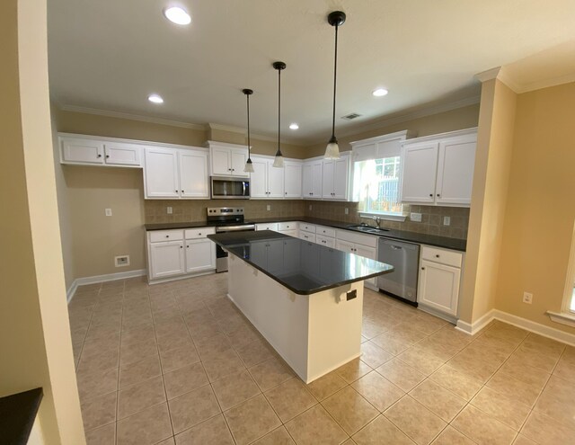 kitchen featuring white cabinets, appliances with stainless steel finishes, and a center island