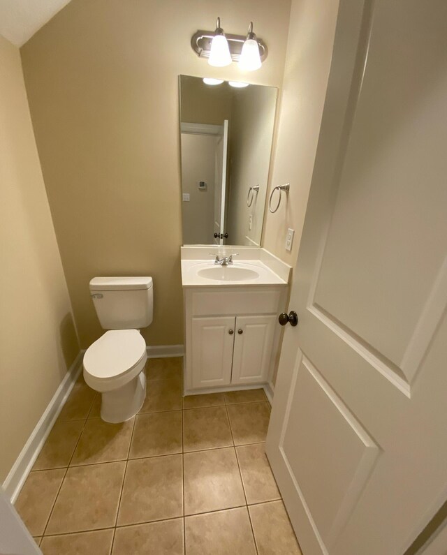 bathroom featuring tile patterned floors, vanity, and toilet