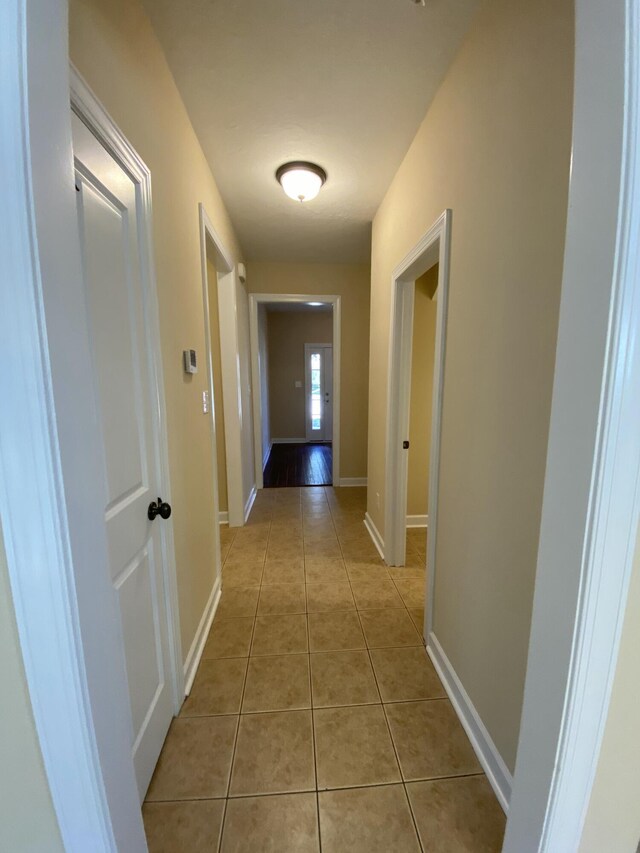 corridor featuring light tile patterned floors