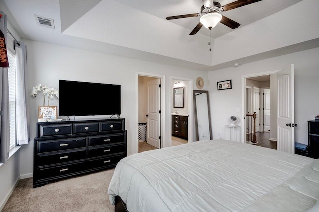 329 Baylor Dr, Graniteville, SC 29829 - carpeted bedroom with a tray ceiling, connected bathroom, and ceiling fan