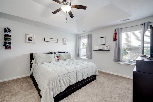 329 Baylor Dr, Graniteville, SC 29829 - bedroom featuring carpet flooring, multiple windows, a tray ceiling, and a ceiling fan