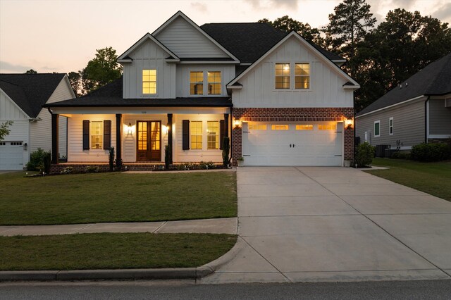 529 River Oaks Ln, Evans, GA 30809 - modern farmhouse with board and batten siding, covered porch, a lawn, and a garage