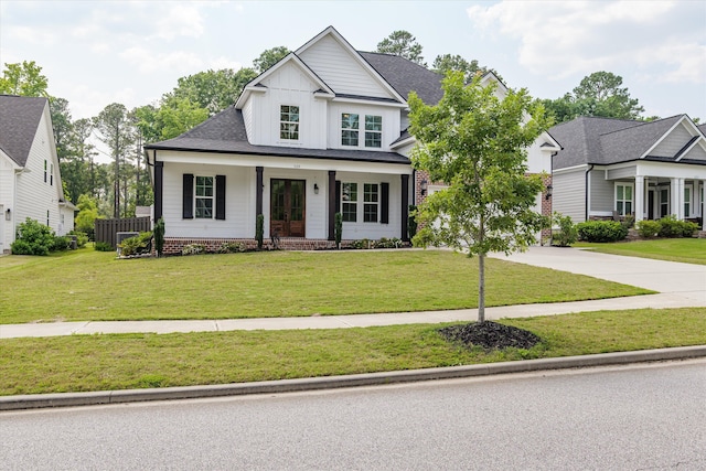 529 River Oaks Ln, Evans, GA 30809 - view of front facade featuring board and batten siding, covered porch, driveway, and a shingled roof