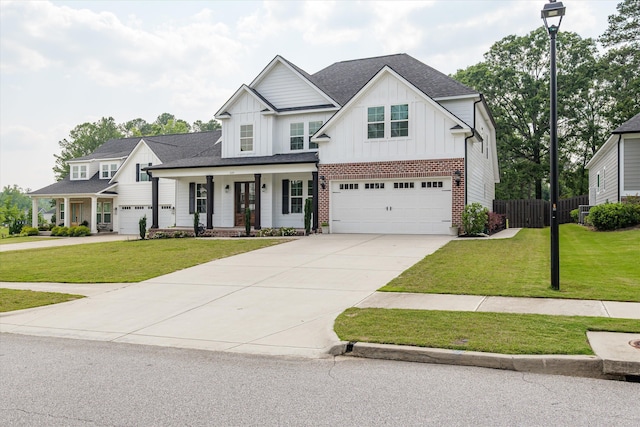 529 River Oaks Ln, Evans, GA 30809 - modern farmhouse style home featuring board and batten siding, concrete driveway, covered porch, a garage, and brick siding