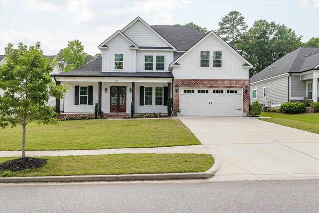 529 River Oaks Ln, Evans, GA 30809 - modern farmhouse with board and batten siding, driveway, a porch, and a front lawn