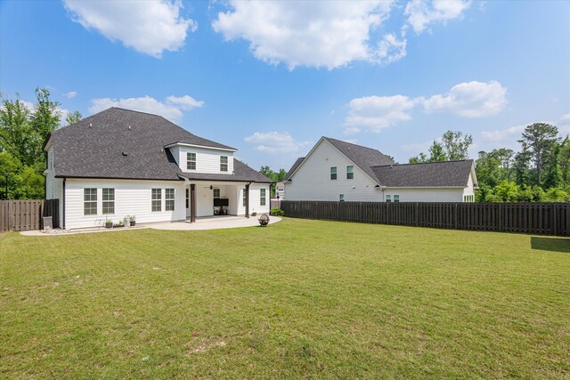 529 River Oaks Ln, Evans, GA 30809 - back of house with a patio area and roof with shingles