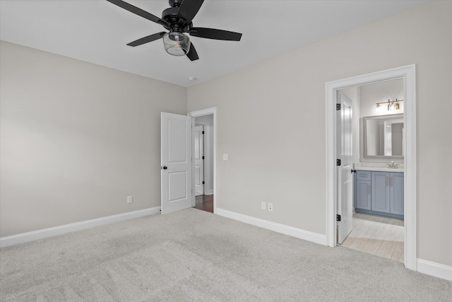 529 River Oaks Ln, Evans, GA 30809 - unfurnished bedroom with light carpet, baseboards, ensuite bath, and a sink