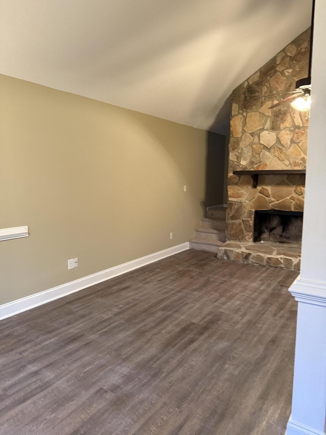 unfurnished living room featuring lofted ceiling, a fireplace, ceiling fan, and dark hardwood / wood-style floors