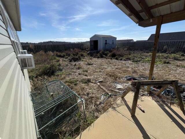 view of yard featuring ac unit and a shed