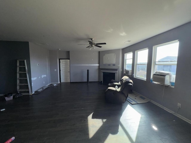 living room featuring dark wood-type flooring, ceiling fan, and cooling unit