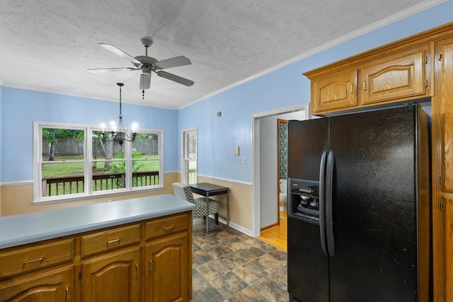 1116 Wrights Mill Rd, Aiken, SC 29801 - kitchen with black fridge, ceiling fan, light countertops, brown cabinets, and a textured ceiling