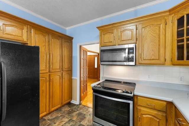 1116 Wrights Mill Rd, Aiken, SC 29801 - kitchen featuring stainless steel appliances, tasteful backsplash, light countertops, crown molding, and brown cabinets