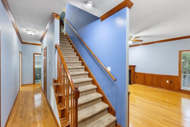 1116 Wrights Mill Rd, Aiken, SC 29801 - stairway with a textured ceiling, wood finished floors, crown molding, a ceiling fan, and a wainscoted wall