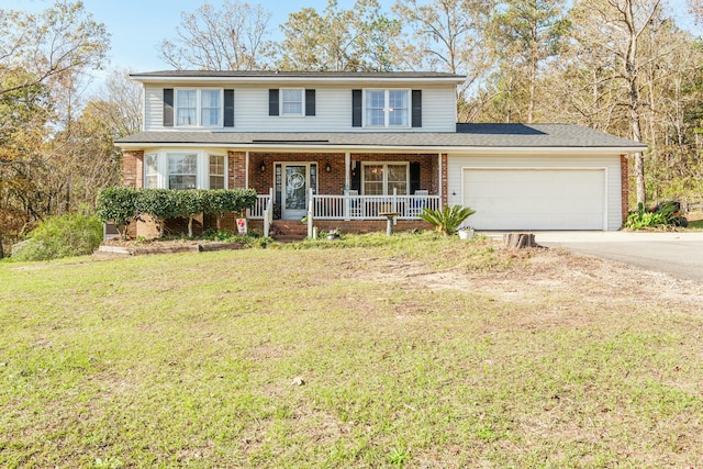 view of property with a porch, a garage, and a front lawn