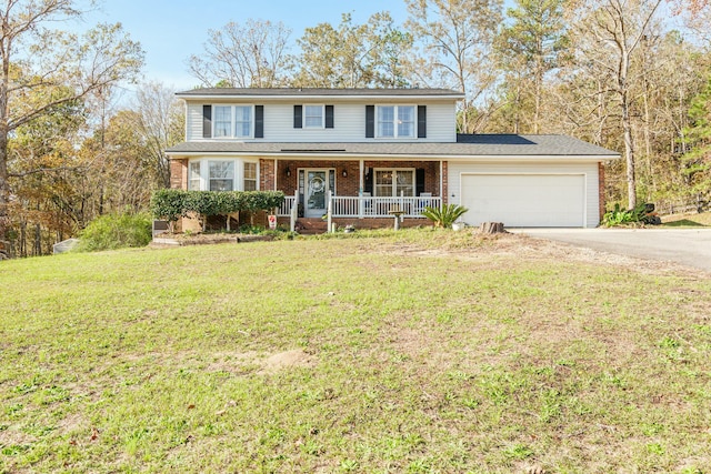 front of property with a porch, a garage, and a front lawn