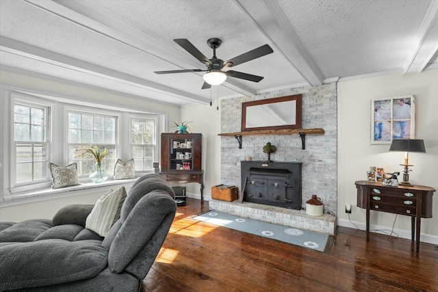 living room featuring beam ceiling, a textured ceiling, dark hardwood / wood-style floors, and a wood stove