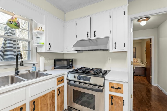 kitchen with white cabinets, stainless steel gas stove, sink, and dark wood-type flooring