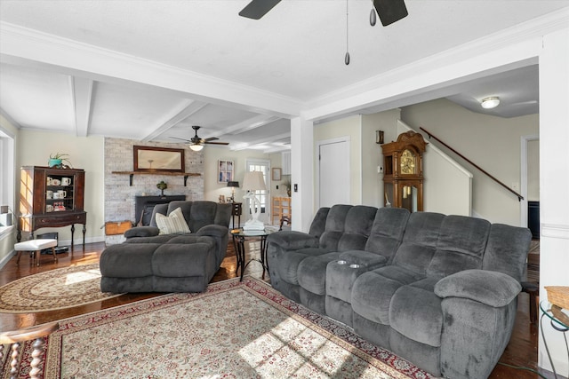 living room featuring ceiling fan, beam ceiling, dark wood-type flooring, and a wealth of natural light