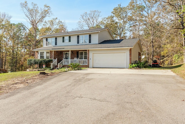 view of property with a porch and a garage