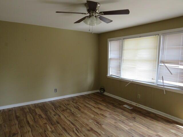 spare room with ceiling fan and hardwood / wood-style floors