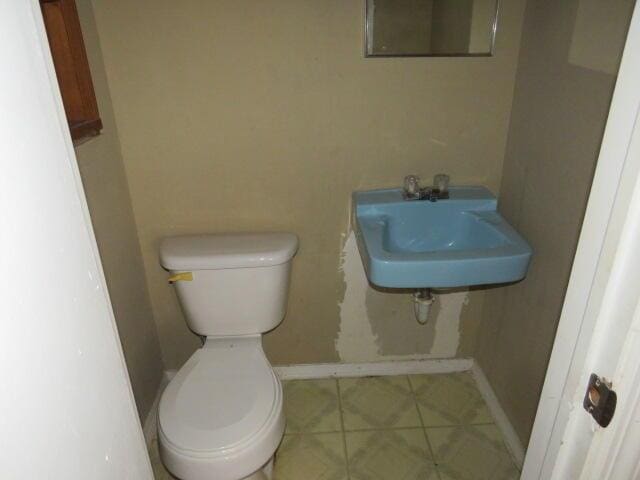 bathroom with sink, tile patterned floors, and toilet