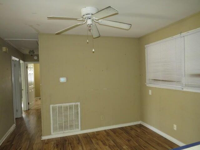 unfurnished room with dark hardwood / wood-style floors and ceiling fan