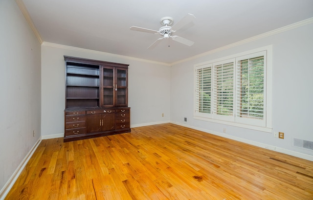 spare room with light hardwood / wood-style flooring, ceiling fan, and crown molding