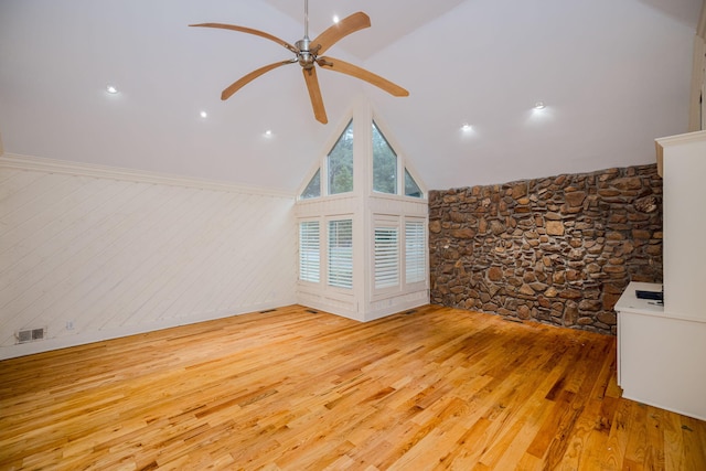 interior space with lofted ceiling, ceiling fan, and light wood-type flooring