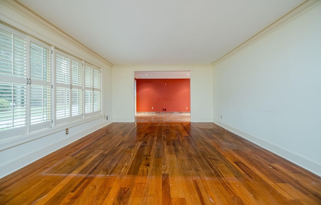 spare room with hardwood / wood-style flooring and ornamental molding