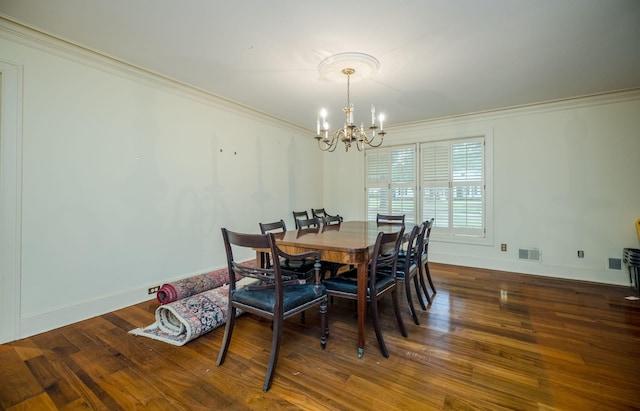 dining room featuring a chandelier, dark hardwood / wood-style floors, and crown molding