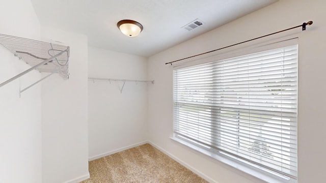 walk in closet with carpet flooring and visible vents