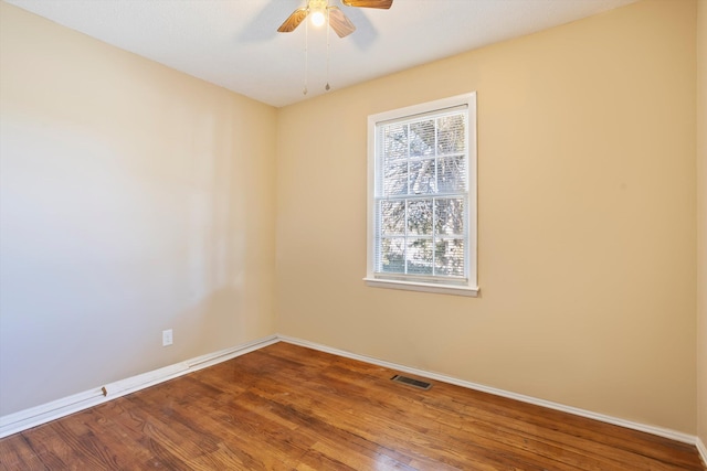 spare room with wood-type flooring and ceiling fan