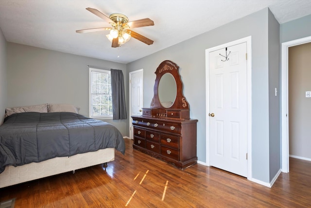 bedroom with ceiling fan and dark hardwood / wood-style flooring