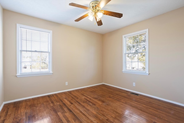 spare room featuring ceiling fan and dark hardwood / wood-style flooring