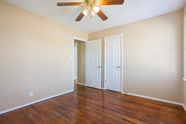 unfurnished bedroom with dark wood-type flooring and ceiling fan