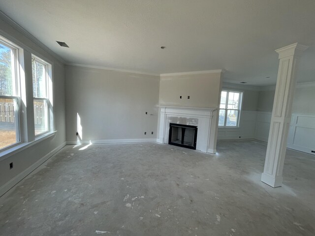 unfurnished room with ceiling fan with notable chandelier, ornate columns, crown molding, and light hardwood / wood-style flooring