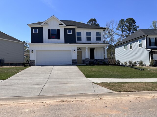 view of front facade featuring a garage and a front lawn