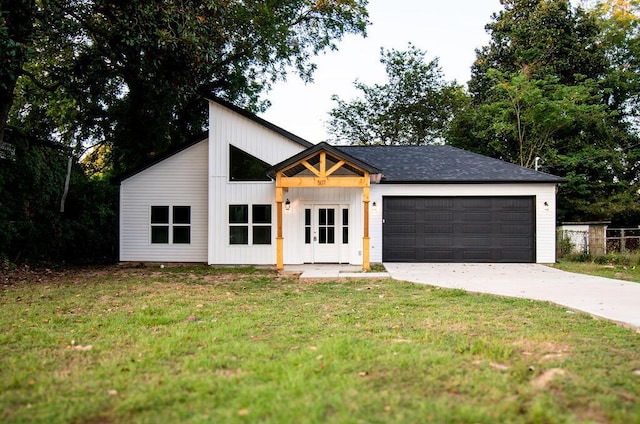 view of front of home with a garage and a front lawn