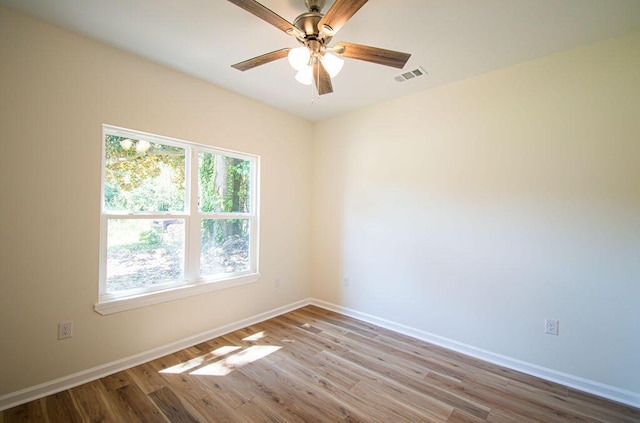 spare room with ceiling fan and light wood-type flooring