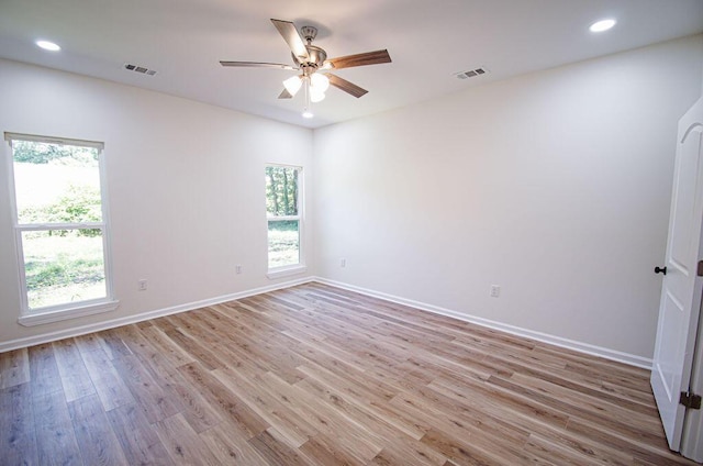 unfurnished room featuring light hardwood / wood-style floors, a wealth of natural light, and ceiling fan