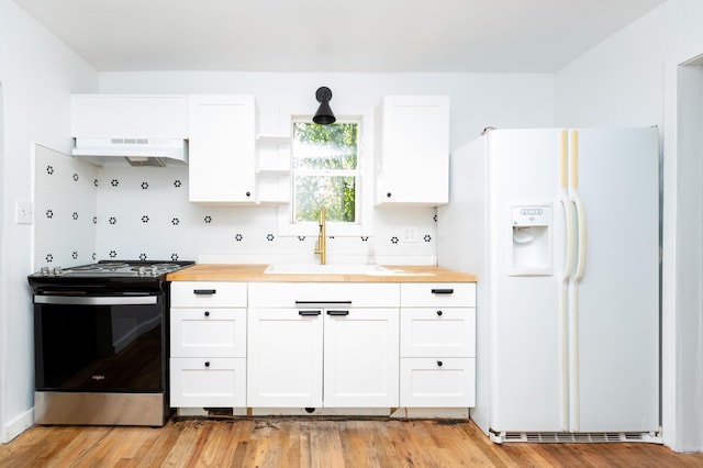 1468 Dewitt St, Augusta, GA 30901 - kitchen featuring white fridge with ice dispenser, stainless steel range, custom exhaust hood, and butcher block countertops