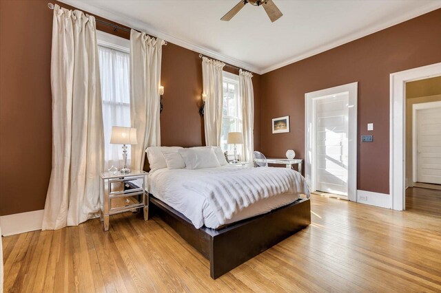 bedroom featuring ceiling fan, crown molding, and light hardwood / wood-style flooring