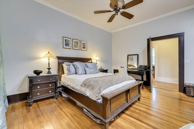 bedroom featuring ceiling fan, ornamental molding, and light hardwood / wood-style flooring